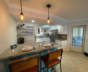 a kitchen with a large island in a room at Beautiful Intracoastal Condo - walk to the beach! 90 day min in West Palm Beach