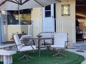 a table with chairs and an umbrella in front of a house at romantic place by the river in Miami