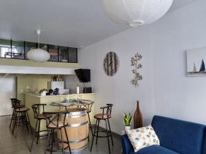 ein Wohnzimmer mit einem blauen Sofa und einem Tisch in der Unterkunft L’EFFERVESCENT in Reims