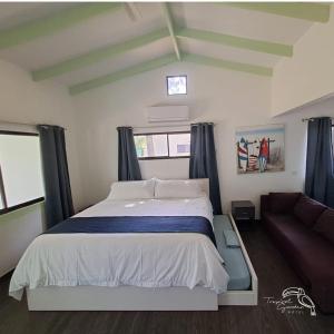 a bedroom with a large bed and a couch at Tropical Garden Hotel in Jacó +72 photos