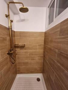 een badkamer met een douche en houten wanden bij Bolivia Sea View Santa Pola in Santa Pola