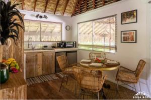 a kitchen with a table and chairs in a room at Villa Noa Noa - Matira in Bora Bora