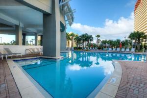 a swimming pool at a hotel with blue water at Laketown Wharf 335! 1 BD, 2 Bathroom with Amazing Amenities in Panama City Beach