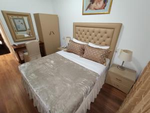 a bedroom with a large bed with a large headboard at Queens Leriotis Hotel in Piraeus +44 photos