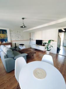 a living room with a couch and a table at Superbe appartement duplex centre ville de Macon in Mâcon