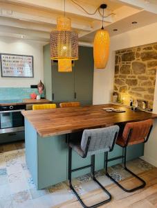 - une cuisine avec un comptoir en bois dans l'établissement Saint Malo - Jolie Maison avec Jacuzzi 150m gare, à Saint-Malo