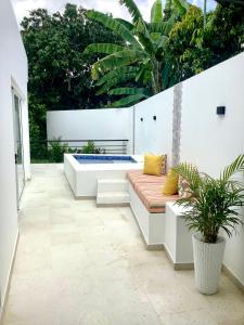 a patio with a bench and a hot tub at La Masia Hotel Boutique in Anapoima