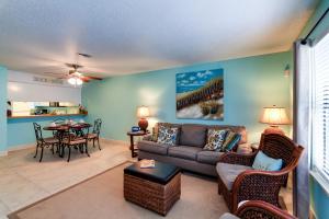 a living room with a couch and a table at Destin Townhome with Balcony - Walk to the Beach! in Destin