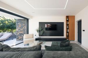 a living room with a couch and a glass table at Black Caviar in Asprouliánoi