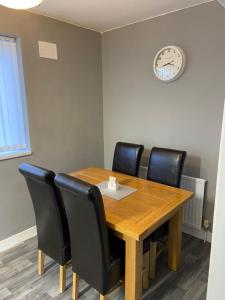a conference room with a wooden table and black chairs at Sheffield spa view 2 bed house free parking in Sheffield