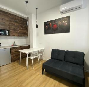 a living room with a table and a couch at Апартаменти в Гранях in Dnipro