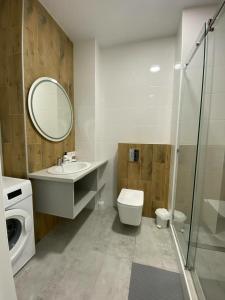 a bathroom with a sink toilet and a mirror at Апартаменти в Гранях in Dnipro
