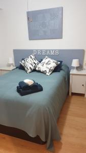 a bed with pillows on it in a room at Ático Berni in Santa Pola