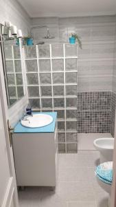 a bathroom with a sink and a shower and a toilet at Ático Berni in Santa Pola