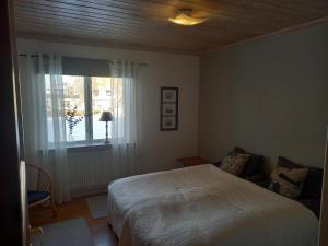 1 dormitorio con cama y ventana en Lägenhet centrala Sollerön, en Sollerön