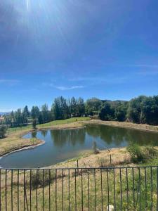 a pond with a fence in front of it at Luxury Home - Vila Golfe Amarante in Amarante