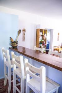 comedor con mesa de madera y sillas blancas en La Nelida Posada in 