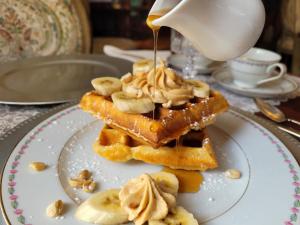 a plate with waffles with bananas and peanut butter at Buffalo Harmony House in Buffalo