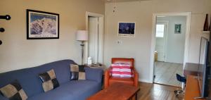 a living room with a blue couch and a table at Midcentury Gem in Midtown Reno in Reno