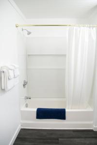 a bathroom with a shower with a blue towel at Westview Centre Motel in Powell River