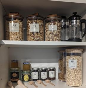 a pantry filled with lots of jars of food at 'Mill Cottage' Parbold in Parbold