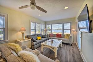 a living room with a couch and a table at Portsmouth Waterfront Vacation Rental with Deck in Portsmouth