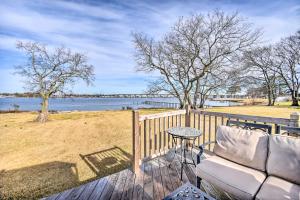 a deck with a couch and a table and a view of the water at Portsmouth Waterfront Vacation Rental with Deck in Portsmouth