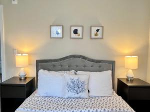 a bedroom with a bed with three pictures on the wall at Luxury 2BR Minutes from Old Town Pasadena in Pasadena