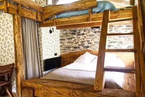 a bedroom with a bunk bed with a ladder at Haraneko errota Goiatzena in El Cerco