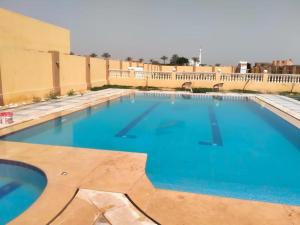 a large swimming pool with blue water at شاليه بالريف الاوربي للاجازات in Giza
