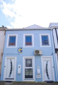 a blue building with two windows on it at My way in Azores in Horta