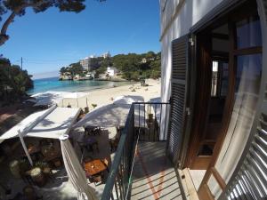 a balcony of a building with a view of a beach at Hostal Playa in Cala Santanyi