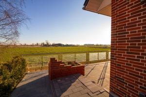a brick building with a view of a field at Ferienhaus Weitblick in Wirdum