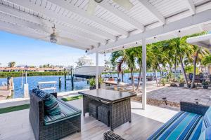 a patio with a table and chairs and the water at Vitamin Sea in Key Colony Beach