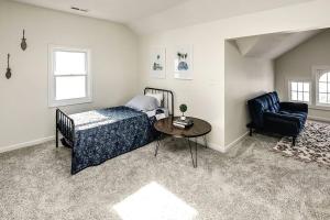 a bedroom with a bed and a table and a chair at Bungalow Adventures in Omaha