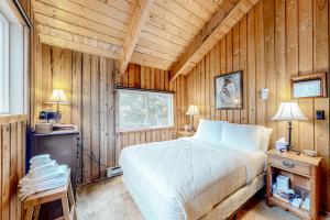 a bedroom with a bed in a wooden wall at Mowing Way Retreat in Wilmington