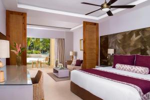 a bedroom with a bed and a living room at Dreams Royal Beach Punta Cana - All Inclusive in Punta Cana