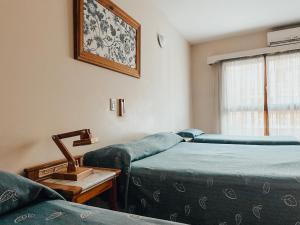 Un pat sau paturi într-o cameră la Posada de San Isidro
