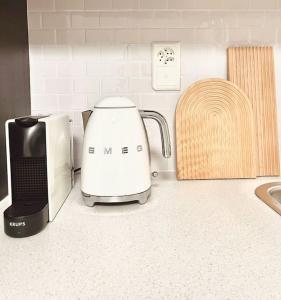 a toaster sitting on a kitchen counter next to a microwave at Bright Tiny Studio - Shared Pool & Sauna - Free Parking - Air condition in Muralto