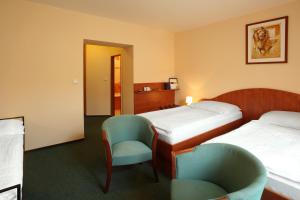 Postel nebo postele na pokoji v ubytování Hotel Palace