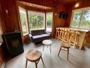 a living room with a couch and a table at CIPRES Ecolodge & Spa in Frutillar