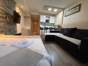 a living room with two beds and a couch at Apartments Konaci Kopaonik in Kopaonik