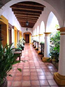 an empty hallway of a building with benches at Hotel Casa Margarita in San Cristóbal de Las Casas