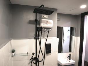 a bathroom with a sink and a shower in it at mySTAY Hotel BGC North in Manila