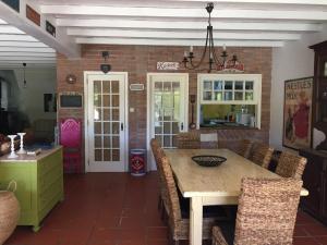 a kitchen with a table and chairs and a brick wall at Casa do Pai Castelo de Bode in Serra +25 photos