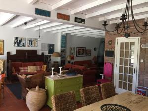 a living room with couches and a table and chairs at Casa do Pai Castelo de Bode in Serra