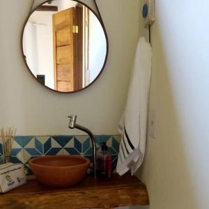 a bathroom with a wooden sink and a mirror at Casa Flor de Dendê, Serra Grande, Bahia in Serra Grande