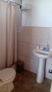 a bathroom with a toilet and a sink at Casa en cineguilla in Cieneguilla