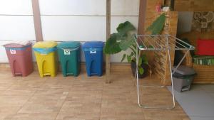 a group of four trash cans lined up in a room at Chalé da Lau in Fernando de Noronha