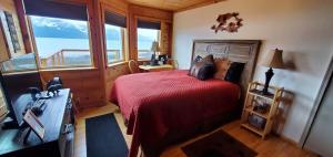 a bedroom with a bed and a view of the ocean at Resurrection Lodge on the Bay in Seward